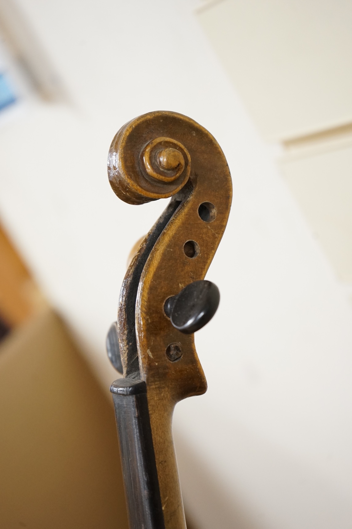 Four violins; a German Dresden violin, together with further two German violins, and a Saxony violin, three in cases or the remains of cases.